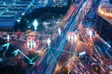 Social media icons hologram on top view of road, busy urban traffic highway at night. Junction...