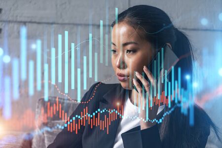 Businesswoman speaks phone and stock market financial chart hologram. Double exposure. Online...