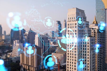 Hologram of social media icons over sunset panoramic cityscape of Bangkok, Asia. The concept of...