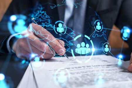 Businessman in suit signs contract. Double exposure with social media and planet hologram. Man...