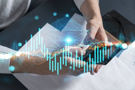 Man typing phone background and financial chart drawing. Multiexposure.