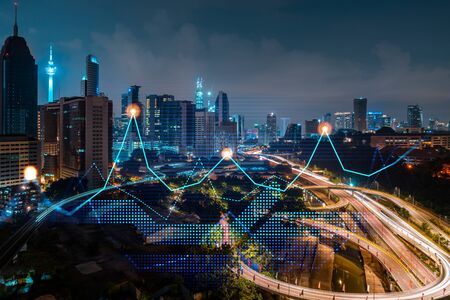 Stock market graph hologram, night panorama city view of Kuala Lumpur. KL is popular location to gain financial education in Malaysia, Asia. The concept of international research. Double exposure.の写真素材