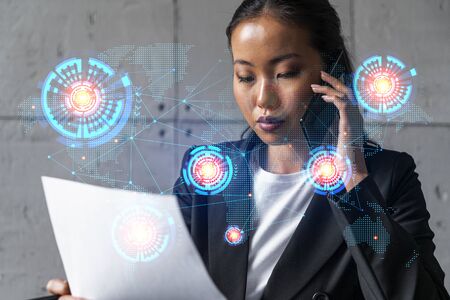 Businesswoman speaks phone and world map hologram. Double exposure.の写真素材