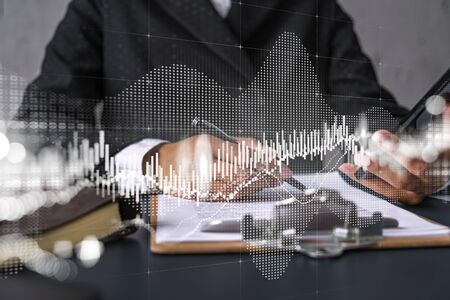 Businesswoman taking notes using smart-phone. Financial forex graph and chart hologram double...