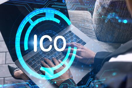 Businesswoman typing on computer in office. ICO icon hologram. Double exposure.