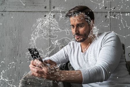 Double exposure of World map drawing hologram and a man searching information on phone in internet.の写真素材