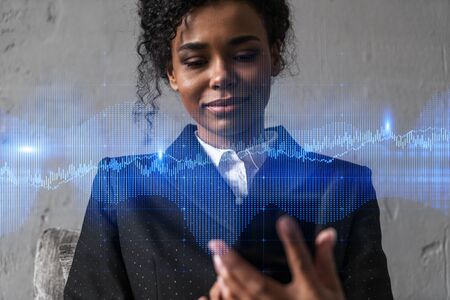 Businesswoman typing phone, work in modern office on new project. forex graph hologram. Double exposure. Concept of success in online trading. Mobile app.の写真素材