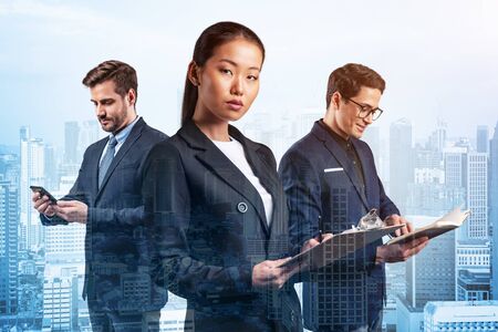 Group of three business colleagues in suits working on project together to gain new career opportunities. Concept of multinational corporate team. Kuala Lumpur. Double exposure.の写真素材