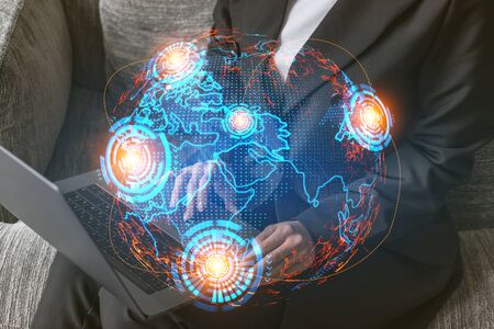 Double exposure of businesswoman typing computer background and world map hologram. Inernational business.の写真素材