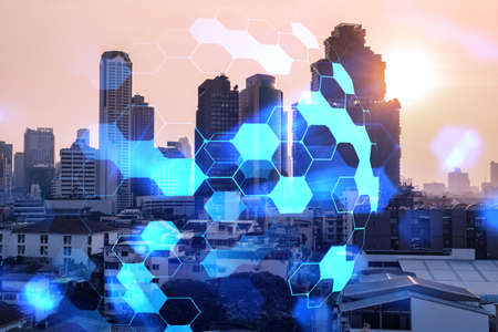 Hologram of abstract technology glowing icons, panoramic cityscape of Bangkok at sunset, Asia. The concept of worlds technological changes. Double exposure.の写真素材