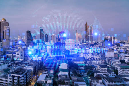 Glowing hologram of Earth planet map on aerial panoramic cityscape of Bangkok at sunset, Asia. The concept of international business. Multi Exposure.の写真素材