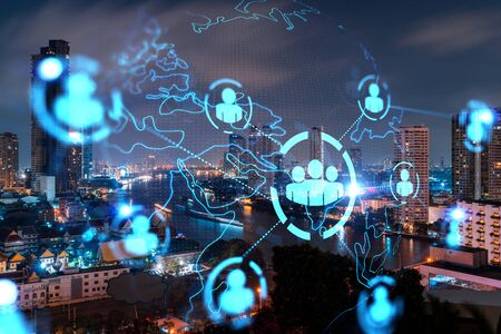 Glowing Social media icons on night panoramic city view of Bangkok, Asia. The concept of networking...