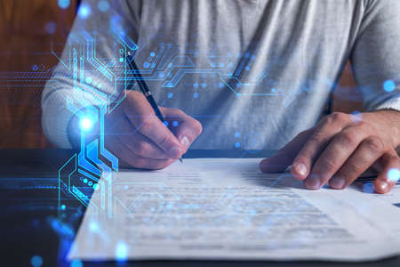 Double exposure of man signing papper and technology theme hologram. Blue infographic of high-tech....