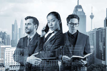 Group of three business colleagues in suits working on project together to gain new career...