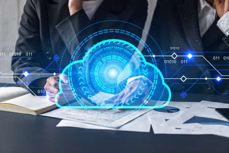 Two businesswomen working together in office. Cloud holographic illustration double exposure.
