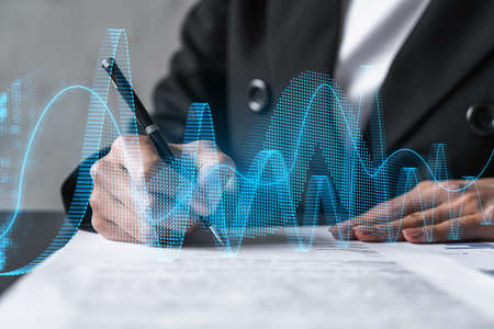 Woman signs agreement. Financial market chart and graph hologram. Double exposure . Business...