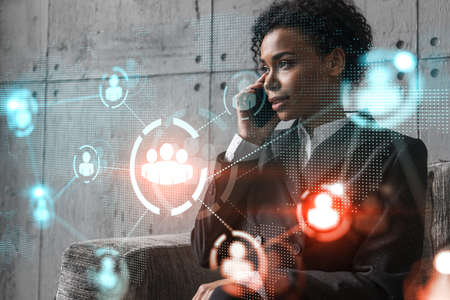 Businesswoman speaks phone and social network hologram. Double exposure.の写真素材