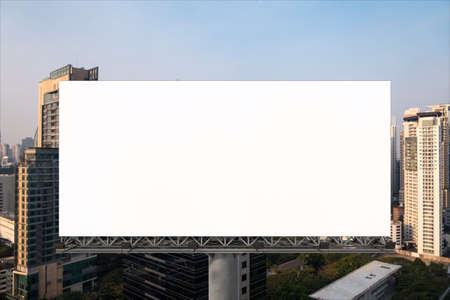 Blank white road billboard with Bangkok cityscape background at sunset. Street advertising poster,...