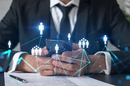 Businessman using on-line app on phone. social network icons hologram. Multiexposure. People...