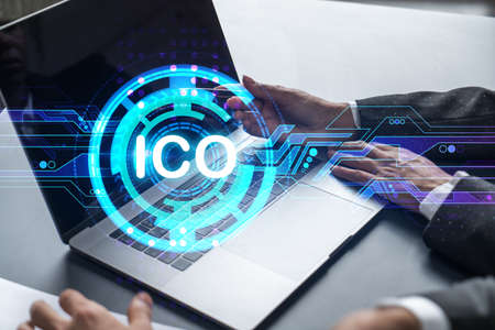 Two business people working together on white paper to release ICO project on market. Try to analyze...