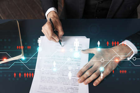 Businessman in suit signs contract. Double exposure with social network hologram. Man signing agreement on smm and analysis. International network concept.の写真素材