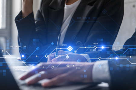 Two businesswoman working together in office. Technology holographic illustration double exposure.