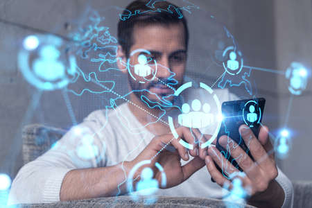 A man typing mobile phone. Double exposure. Social network theme drawing hologram. International...