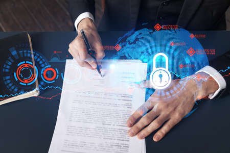 Businessman in suit signs contract. Double exposure with lock icon hologram. Man signing agreement...