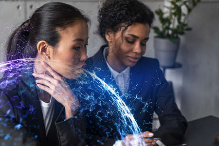 Two businesswomen work together in modern office on new project. Double exposure. Concept of...