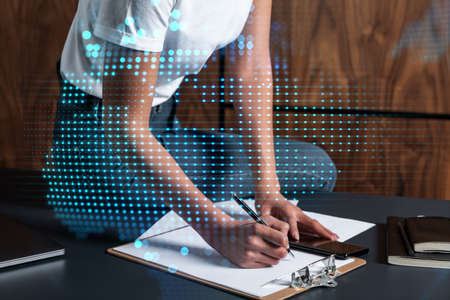 Businesswoman taking notes using smart-phone. World map hologram double exposure.