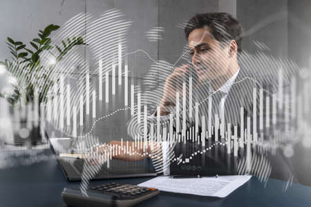 Businessman in office working with laptop technology forex online trading graph and chart, typing...