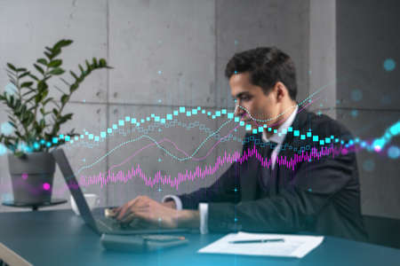 Businessman in office working with laptop technology forex online trading graph and chart, typing...