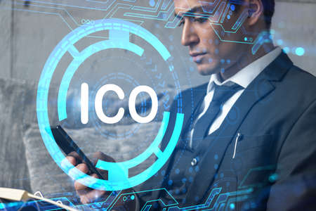 Analyst in office working with Smartphone, ICO hologram, typing phone. Double exposure.