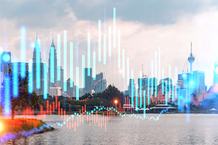 Glowing FOREX graph hologram, aerial panoramic cityscape of Kuala Lumpur at sunset. Stock and bond trading in KL, Malaysia, Asia. The concept of fund management. Double exposure.の写真素材