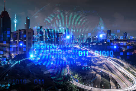 Hologram of Earth planet map on night panoramic cityscape of Kuala Lumpur, Malaysia, Asia. The...