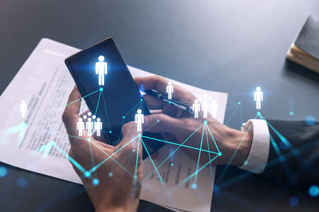 Businessman using on-line app on phone. social network icons hologram. Multiexposure. People connection concept.の写真素材