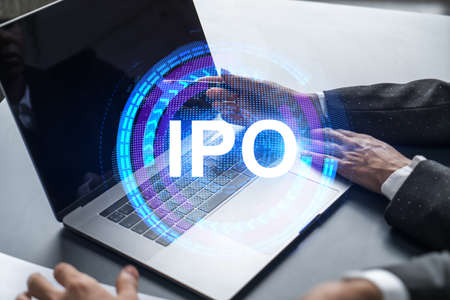 Two business people working together on white paper to release and present IPO project to investors. Initial primary offering hologram. Double exposure.の写真素材