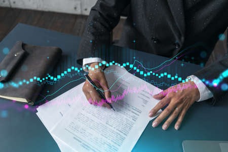 Woman signs agreement. Forex financil market chart and graph hologram. Double exposure . Brokerage...