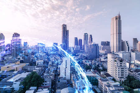 Hologram of abstract technology glowing icons, panoramic cityscape of Bangkok at sunset, Asia. The...