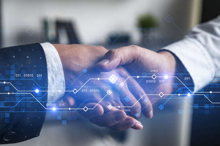 Double exposure of two businesspeople handshake and binary technology hologram drawing background....