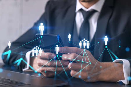 Businessman using on-line app on phone. social network icons hologram. Multiexposure. People connection concept.の写真素材