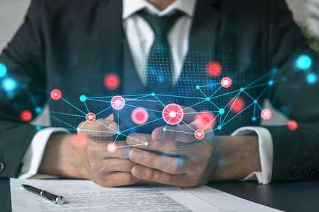 Businessman using app on phone. Abstract technology icons hologram. Multiexposure. People connection concept.の写真素材