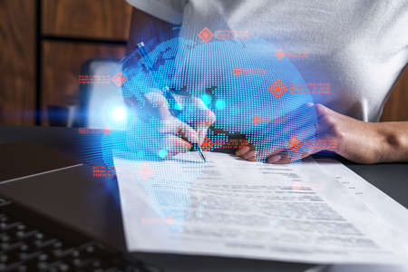 World map and a woman signing papers. Double exposure.の写真素材
