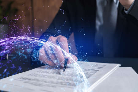 Businessman in suit signs contract. Double exposure with abstract technology hologram. Man signing...