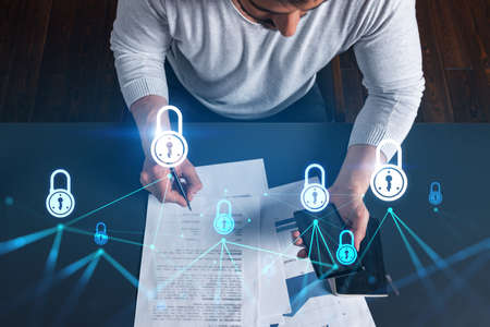 Handsome man working on Data protection project. Multiexposure. Lock icon hologram.