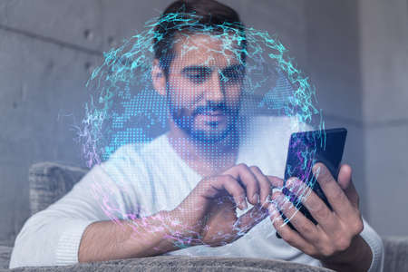 Double exposure of World map drawing hologram and a man searching information on phone in internet.