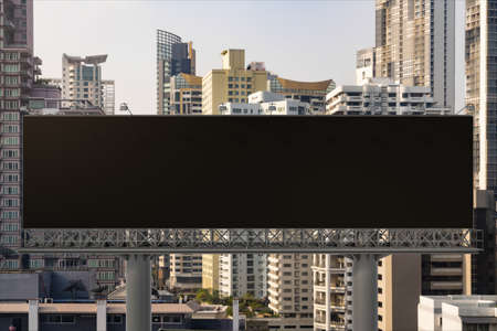 Blank black road billboard with Bangkok cityscape background at day time. Street advertising poster,...