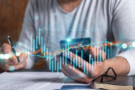Multi exposure of man signing contract with phone and forex chart hologram. Concept of financial...