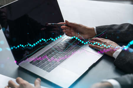 Two business people working together on stock market strategy. Try to analyze forex behavior....