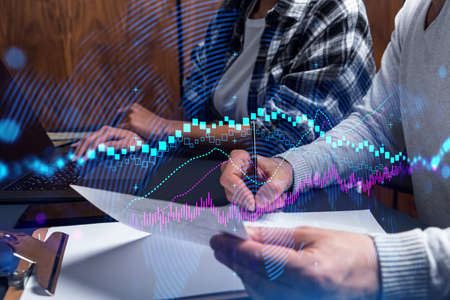 Two business people working together on stock market strategy. Try to analyze forex behavior....